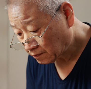 Close-up of artisan’s face, deeply focused while working on a teapot
