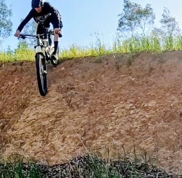 mtb rider riding down a steep roll in