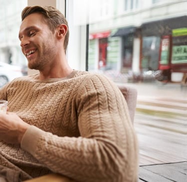 British expat working remotely in Murcia cafe with Allianz health insurance for Spanish visa