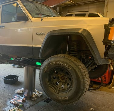Suv on a lift in the middle of an oil change