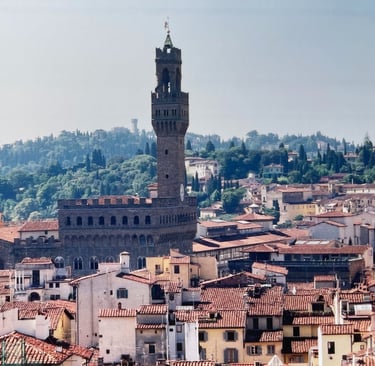 the palazzo vecchio in Florence, Italy, surrounded by other buildings and Tuscan countryside behind