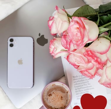 a cup of coffee and a bouquet of roses, a laptop, a phone, a paper and 2 hearts