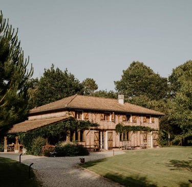 a house with a large wooden house domain de Petiosse