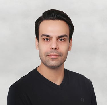 Portrait of a VISUALISE team member in a black shirt, neutral background, soft lighting, and centered composition.