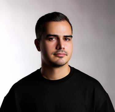Portrait of a VISUALISE team member in a black shirt, neutral background, soft lighting, and centered composition.