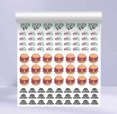 Roll of UV DTF printed stickers featuring burgers and brand logos.