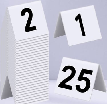 White Acrylic Table Tent with a number 1- 2- 25 with black font, with multiple stacks on 2