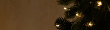 a christmas tree with candles and candles on a dresser