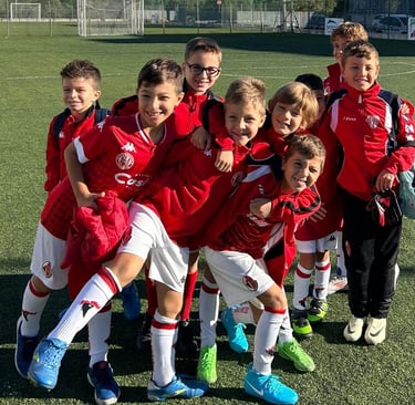 a group of young children soccer players posing for a picture