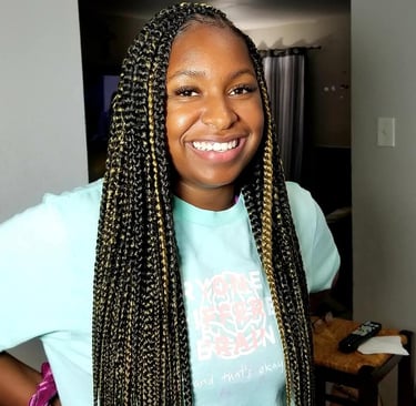 a woman with black and gold box braids