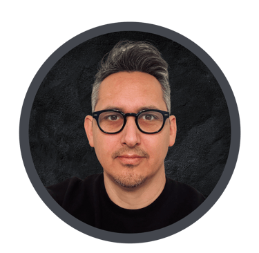 Image of the author with glasses and a black shirt