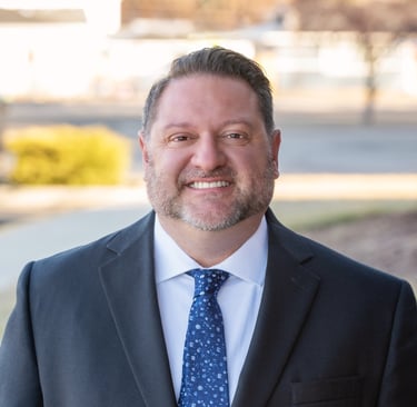 a man in a suit and tie smiling