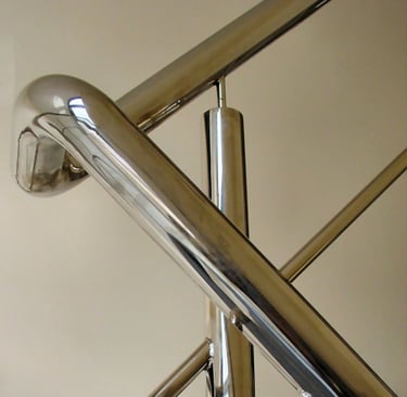 a metal stair case with a metal handrail