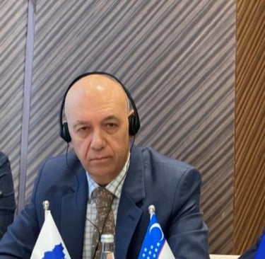 a man in a suit and headphones sitting at a table