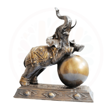 a statue of a man riding a elephant on a ball