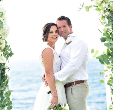 bride and groom standing under arch at wedding at cuvier park in La jolla