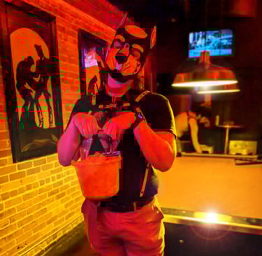 A man in a bar poses wearing a pup mask.