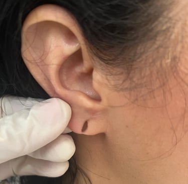 a woman with a white gloved hand holding a pair of gloves