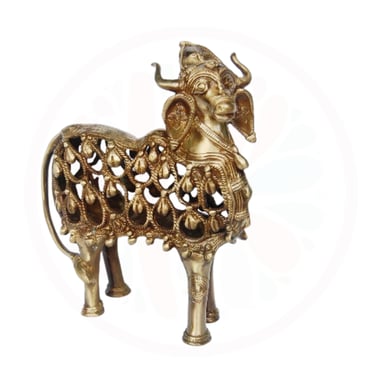 a gold colored metal animal statue of a goat