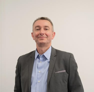 a man in a suit and tie smiling