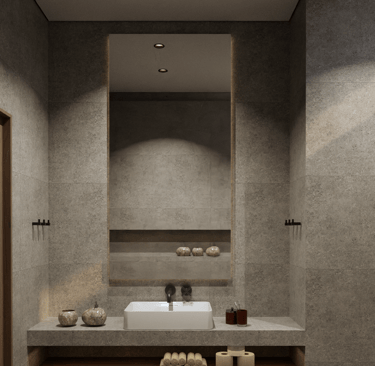Modern bathroom featuring stone tiles and a large illuminated mirror.