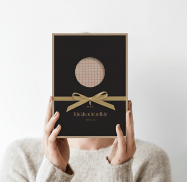 a woman holding a box of duggcandles product