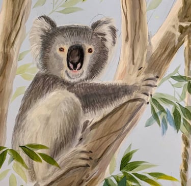 Hand-painted koala resting in a gum tree — Australian nursery mural detail in calm neutral tones.