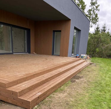 a wooden deck with a bucket of water and a bucket of water