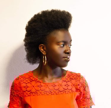 A Black Woman in professional dress with an afro