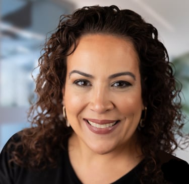 a woman with curly hair and a black shirt