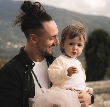 a man with a child on his lap, holding a baby