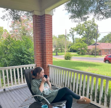 Woman sitting drinking coffee at Main Street House