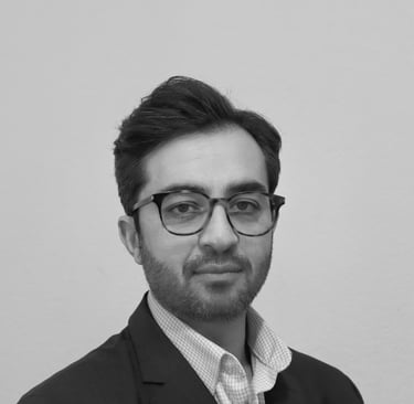 a man in a suit and glasses posing for a picture