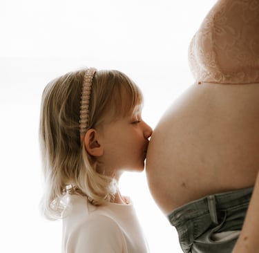 toddler kissing her mum's pregnant belly in studio - Littlehampton, Adelaide Hills