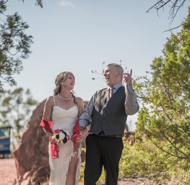 a man and woman walking down a path