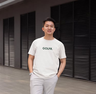 a man in a white shirt and grey pants