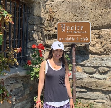 a woman standing in front of a sign
