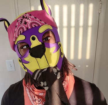 Man posing in pup mask.