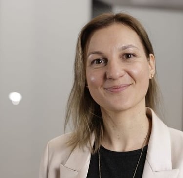 a woman in a white jacket and black shirt