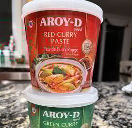 tubs of Aroy-D red and green curry paste
