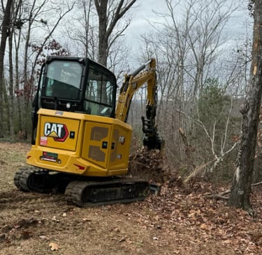 CAT excavator digging up dirt