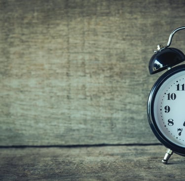 Alarm clock in front of wooden wall