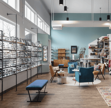 Interior showroom at Edge Optics Fort Collins location, with stylish seating and eyewear to shop