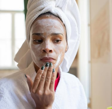 a woman in a white robe is shaving her face