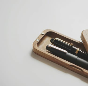 Wooden box holding two cherished pens representing the essence of living with what is meaningful