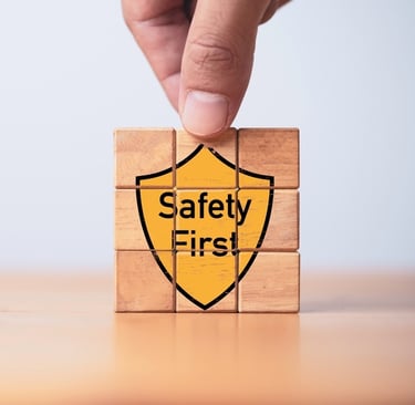 Building blocks with the graphic of a yellow shield saying "Safety First" on the front