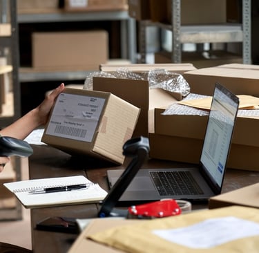 Female eCommerce seller preparing boxes for shipment