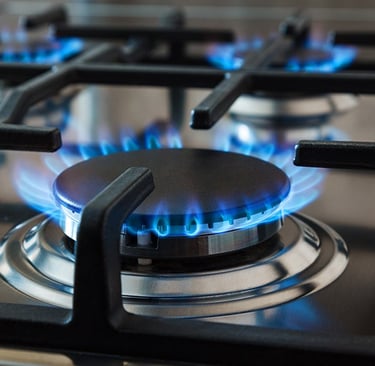a gas stove top with blue flames on it