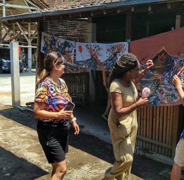 a group of people checking their batik works