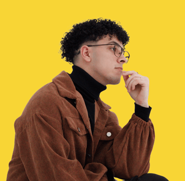 a man in a brown jacket and glasses